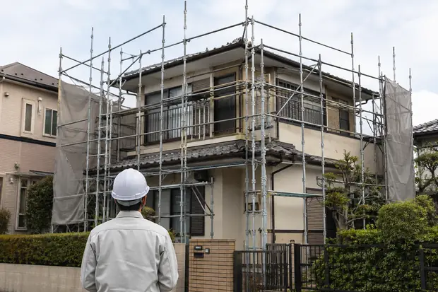 足場を組んだ住宅と現場を確認する様子